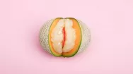 Picture of a melon on a pink background
